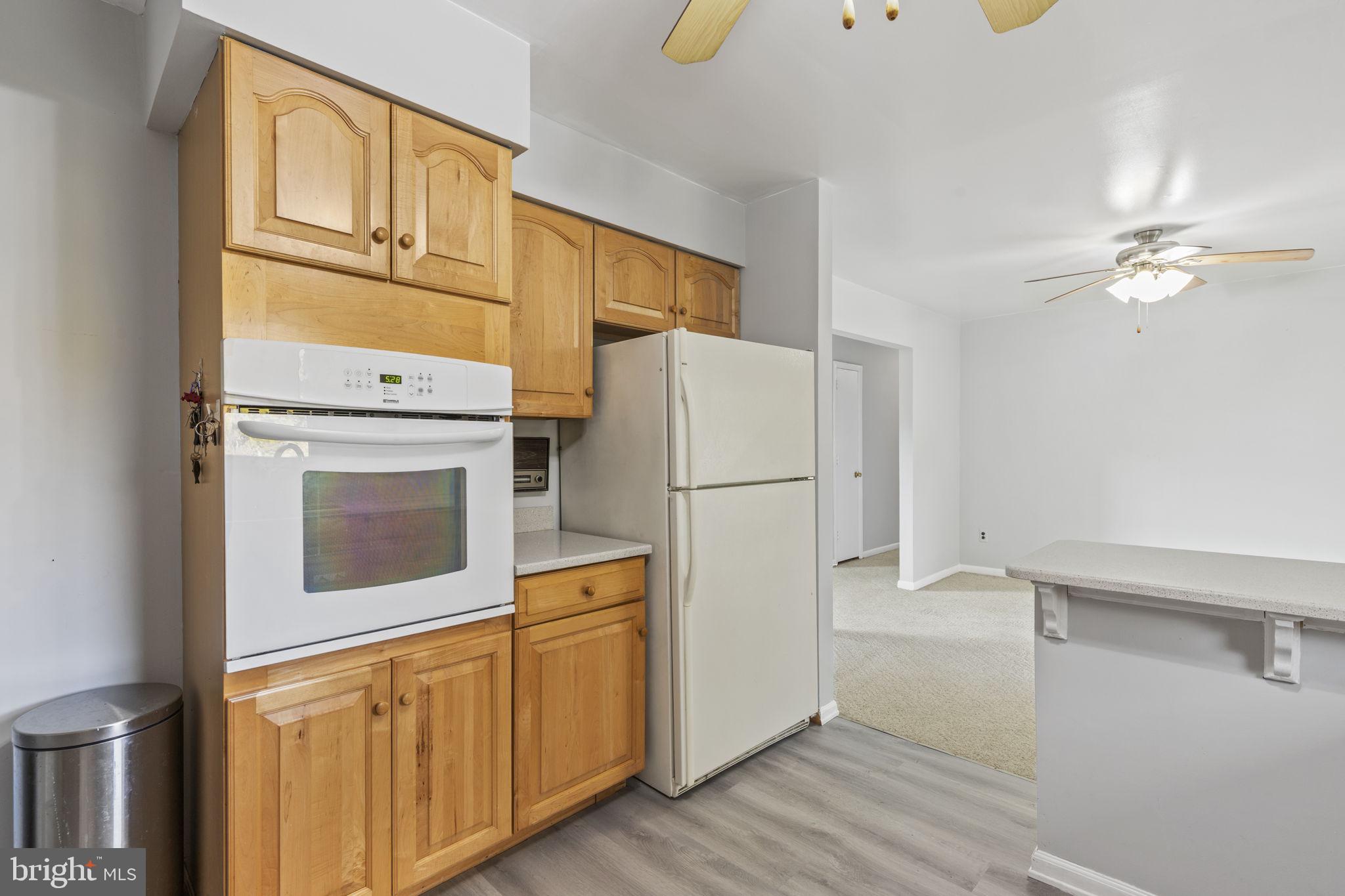 413 Magnolia Road Edgewood, MD 21040 - Photo 12 of 49 a kitchen with cabinets stainless steel appliances and wooden floor