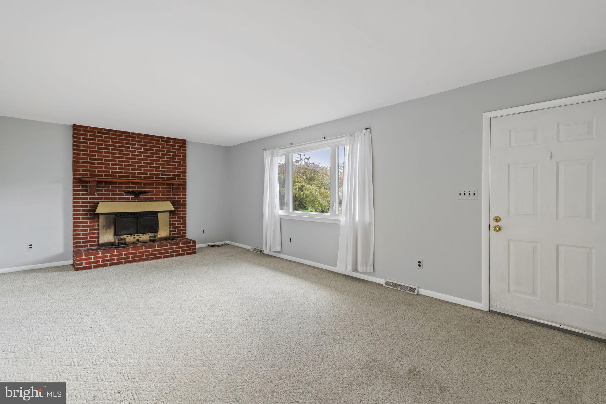 413 Magnolia Road Edgewood, MD 21040 - Photo 2 of 49 an empty room with a fireplace and window
