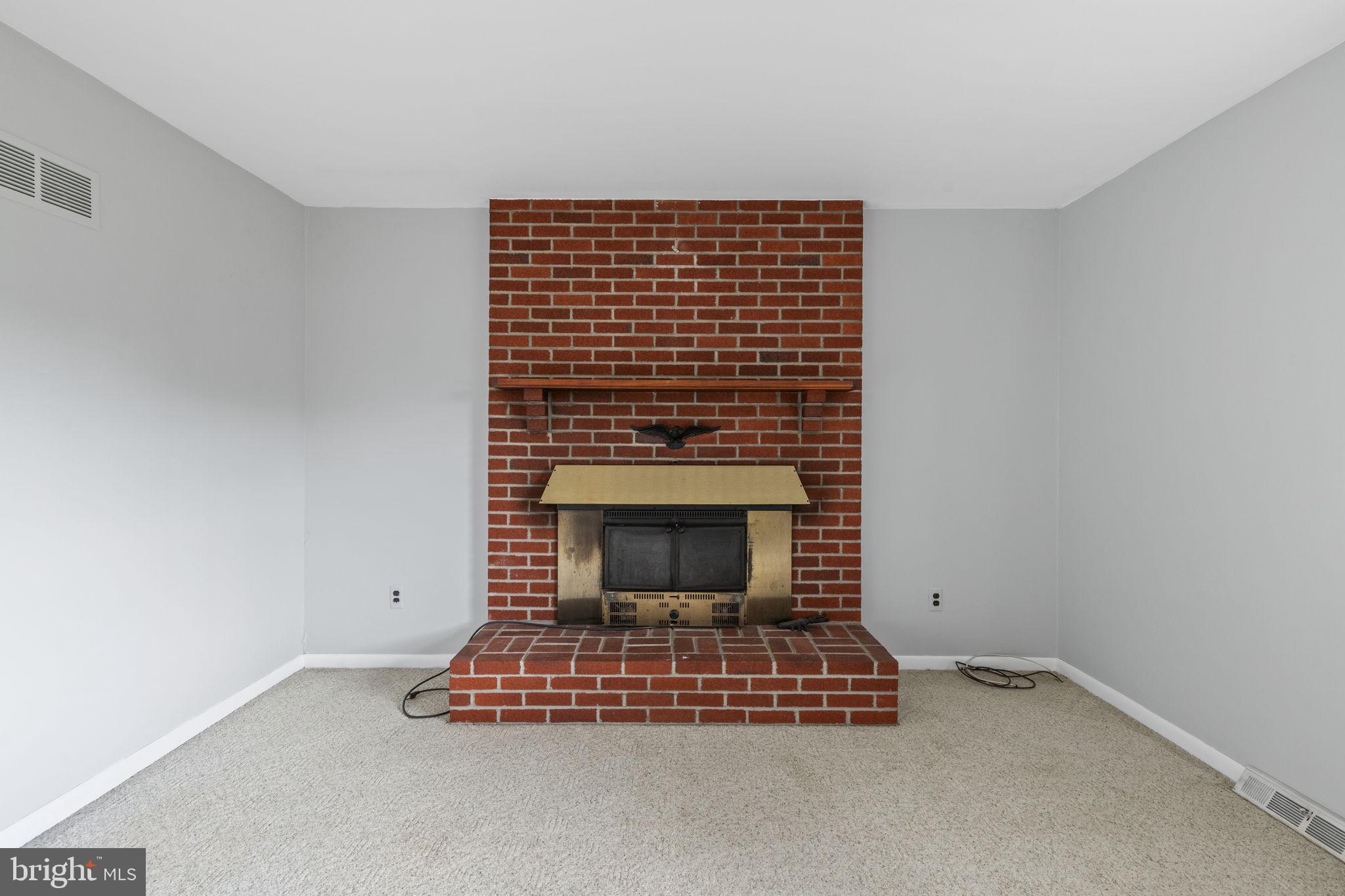 413 Magnolia Road Edgewood, MD 21040 - Photo 5 of 49 a room with a fireplace and a wooden floor