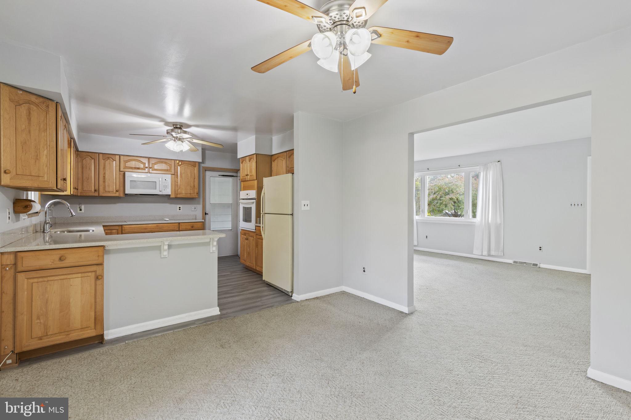 413 Magnolia Road Edgewood, MD 21040 - Photo 7 of 49 a kitchen with white cabinets and refrigerator