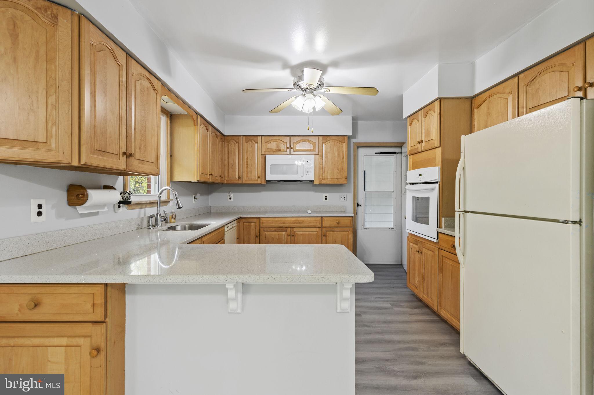 413 Magnolia Road Edgewood, MD 21040 - Photo 9 of 49 a kitchen with granite countertop a refrigerator a sink and dishwasher