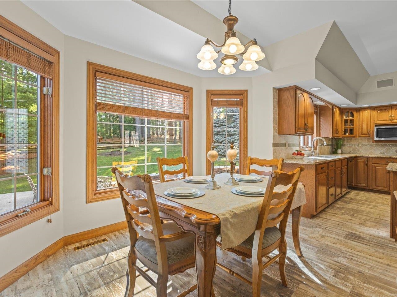 11575 Aberdeen Road Belvidere, IL 61008 - Photo 12 of 46 a view of a dining room with furniture a chandelier and wooden floor