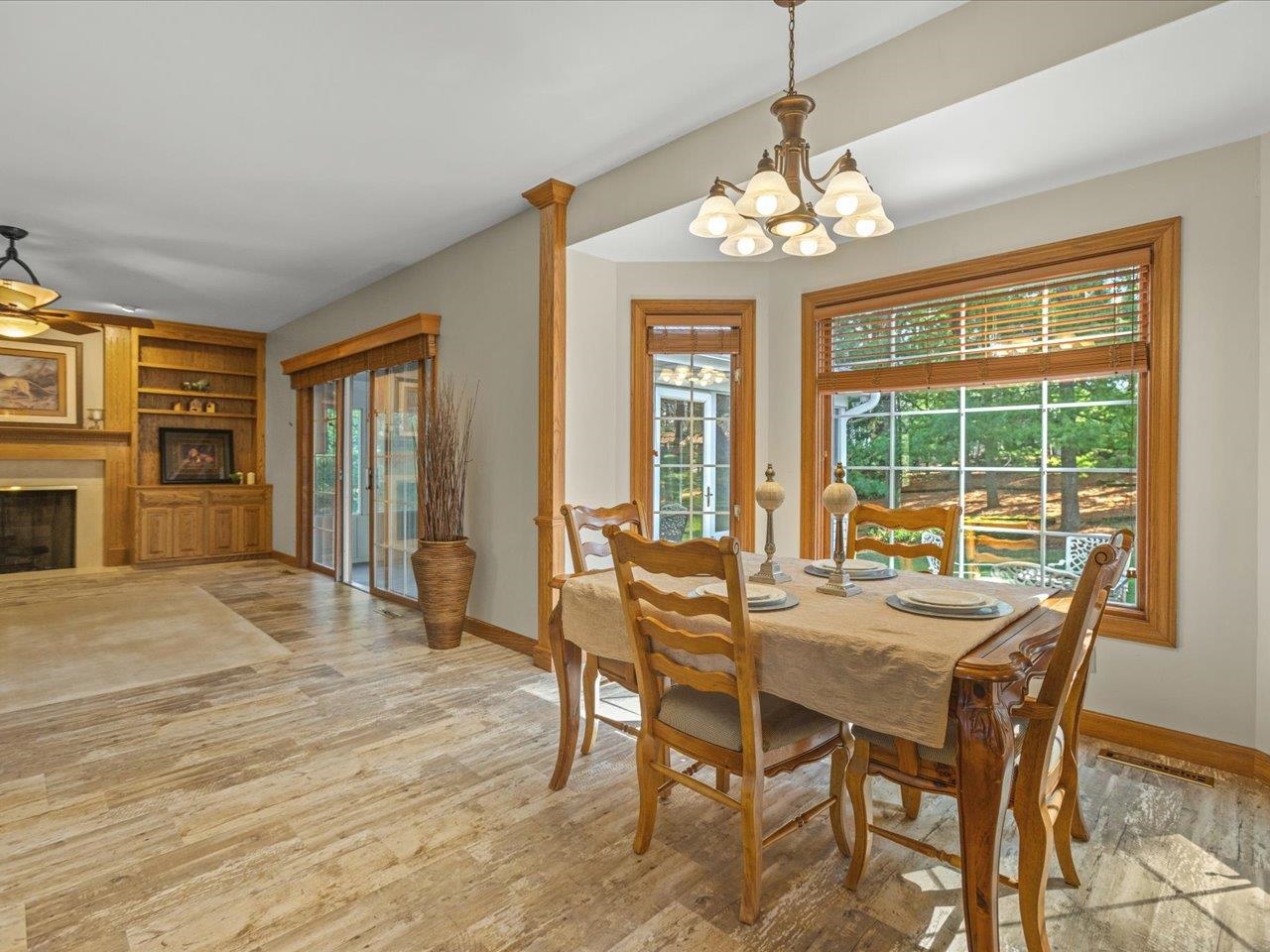 11575 Aberdeen Road Belvidere, IL 61008 - Photo 15 of 46 a dining room with furniture a chandelier and wooden floor