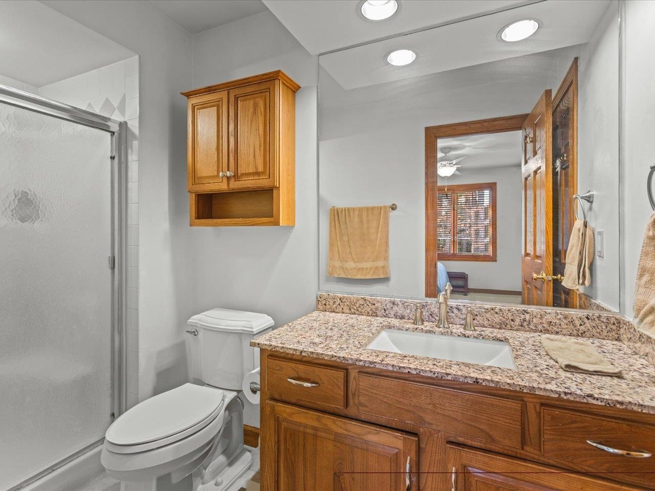 11575 Aberdeen Road Belvidere, IL 61008 - Photo 24 of 46 a bathroom with a granite countertop sink toilet and shower
