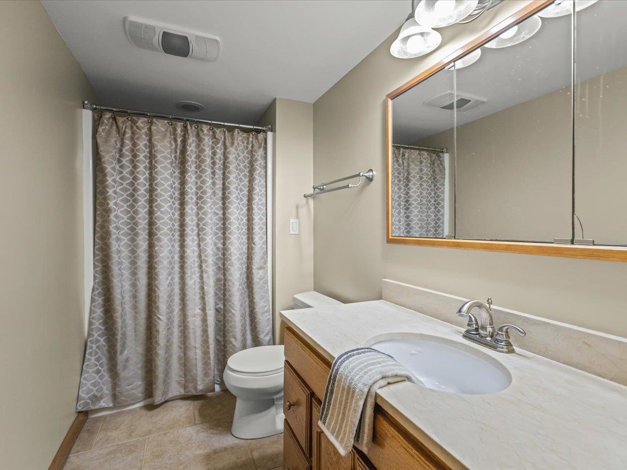 11575 Aberdeen Road Belvidere, IL 61008 - Photo 29 of 46 a bathroom with a granite countertop sink and a mirror