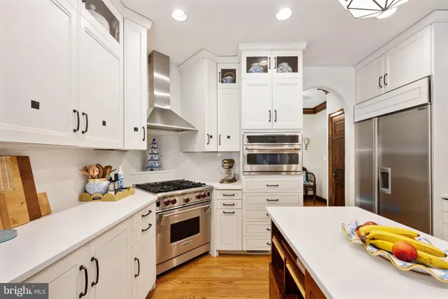 a spacious bedroom with a bed a couch and dresser