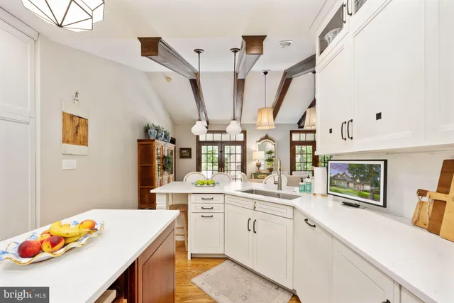 a bathroom with a tub a sink and a mirror