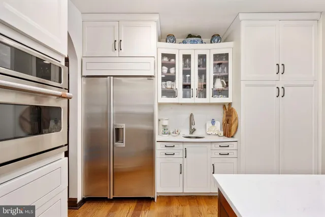 a bathroom with a double vanity sink a large mirror and shower