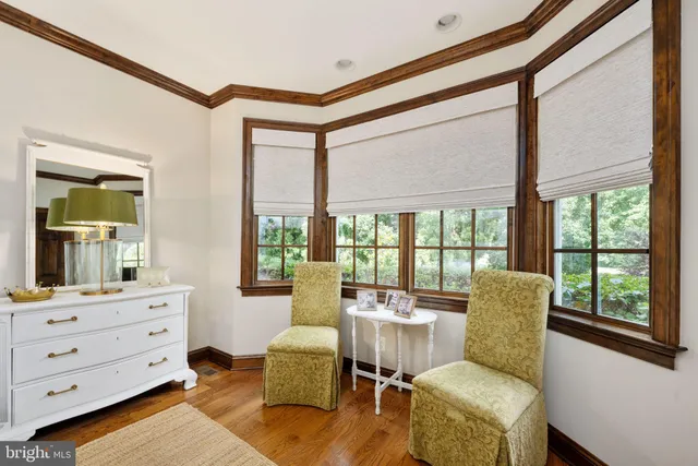 a bedroom with a bed and a tv on the dresser
