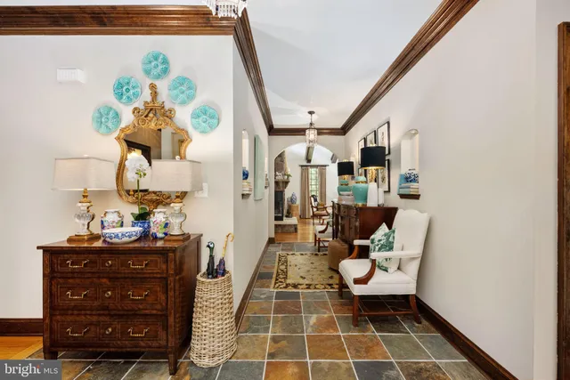 a living room with furniture a fireplace and a floor to ceiling window