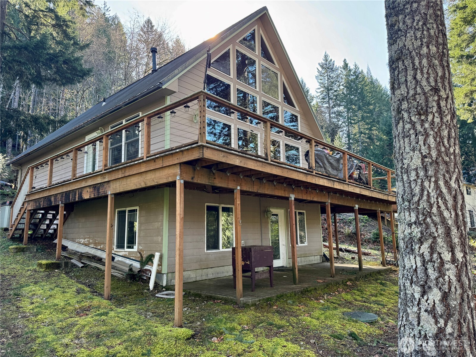 70 Rim View Place Hoodsport, WA 98548 - Photo 1 of 35 a view of a house with a yard and sitting area