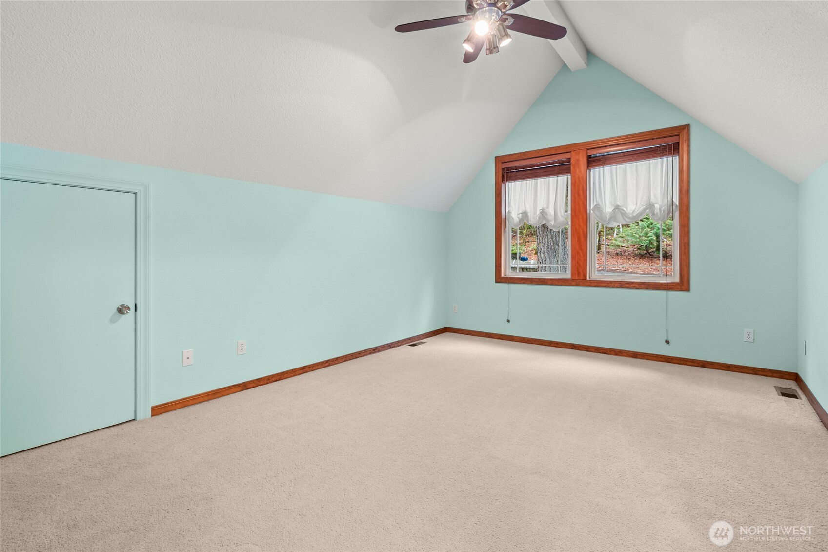 70 Rim View Place Hoodsport, WA 98548 - Photo 16 of 35 an empty room with a chandelier fan and windows