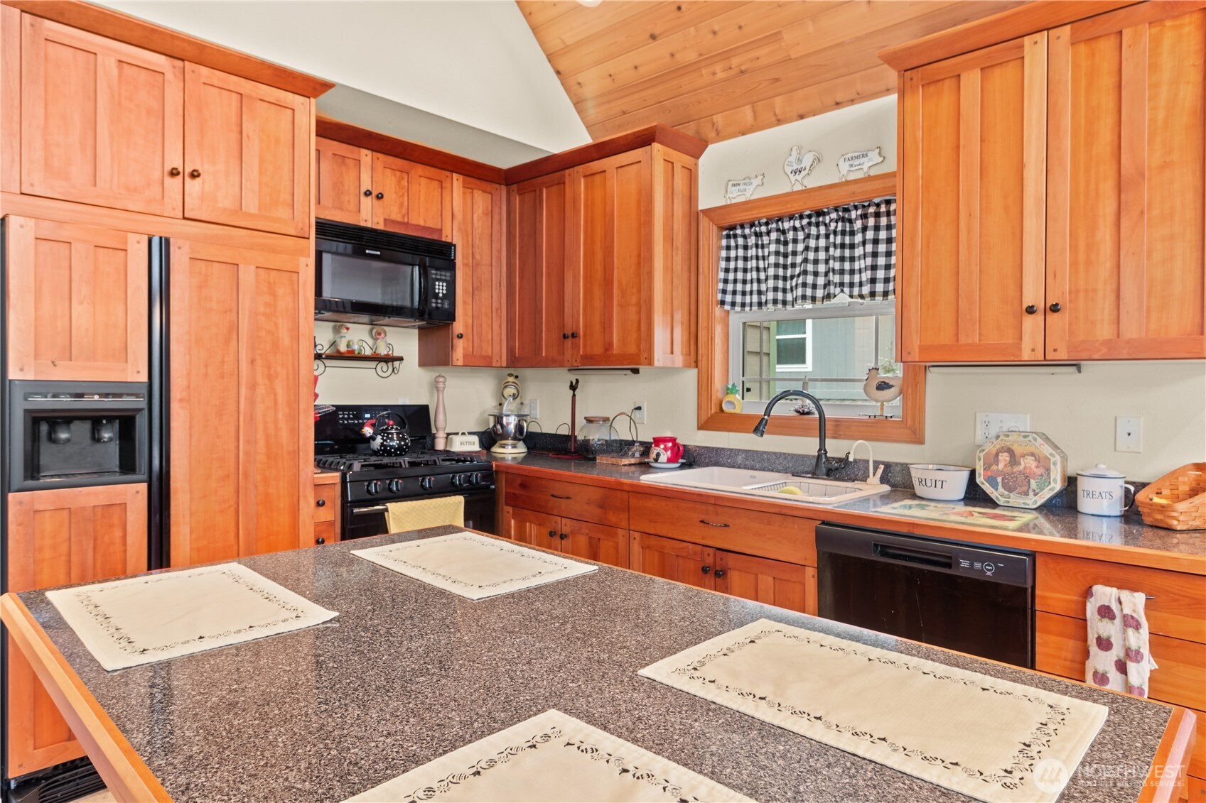 70 Rim View Place Hoodsport, WA 98548 - Photo 10 of 35 a kitchen with stainless steel appliances granite countertop a stove top oven a sink a counter space and cabinets