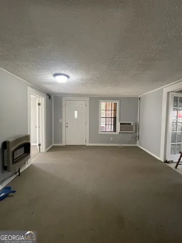 a view of a livingroom with an empty space and a window