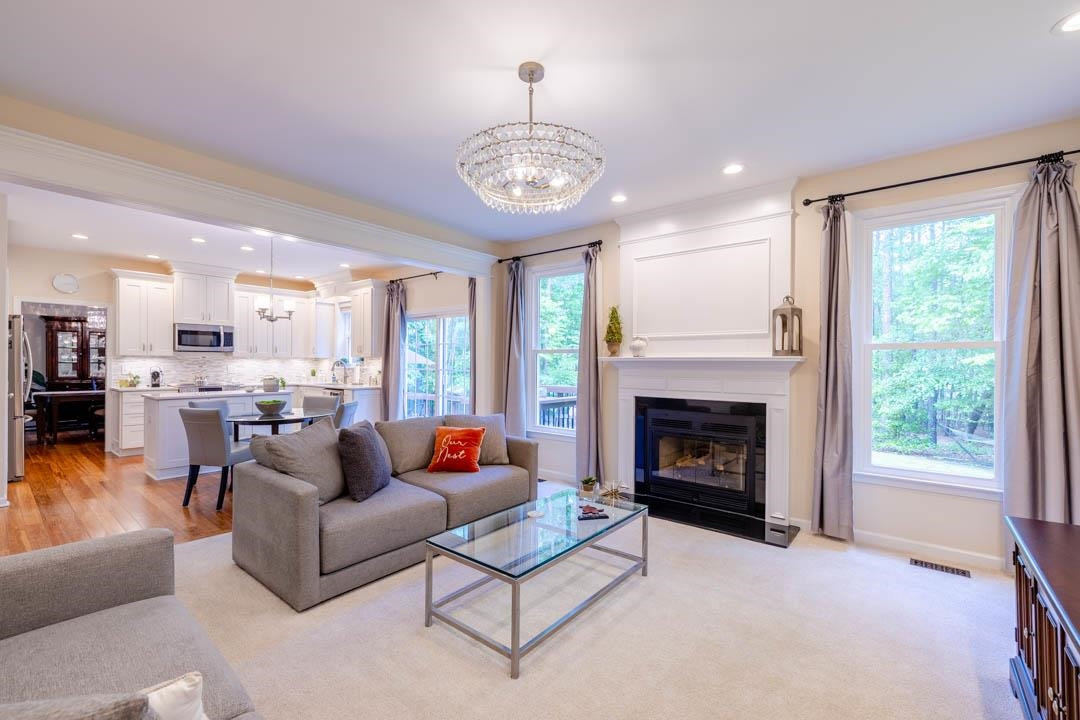 7402 Leapale Lane Durham, NC 27713 - Photo 16 of 41 a living room with furniture a fireplace and a large window