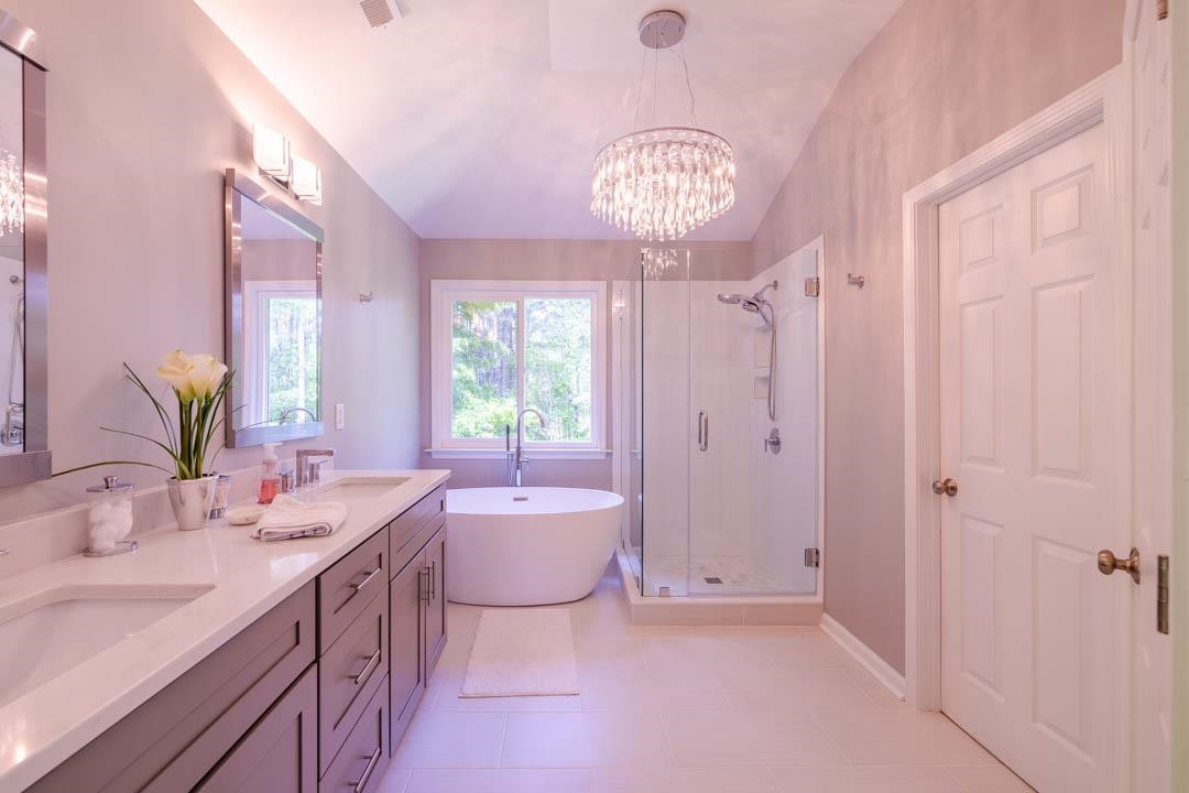 7402 Leapale Lane Durham, NC 27713 - Photo 23 of 41 a spacious bathroom with a sink a mirror a bathtub and a shower