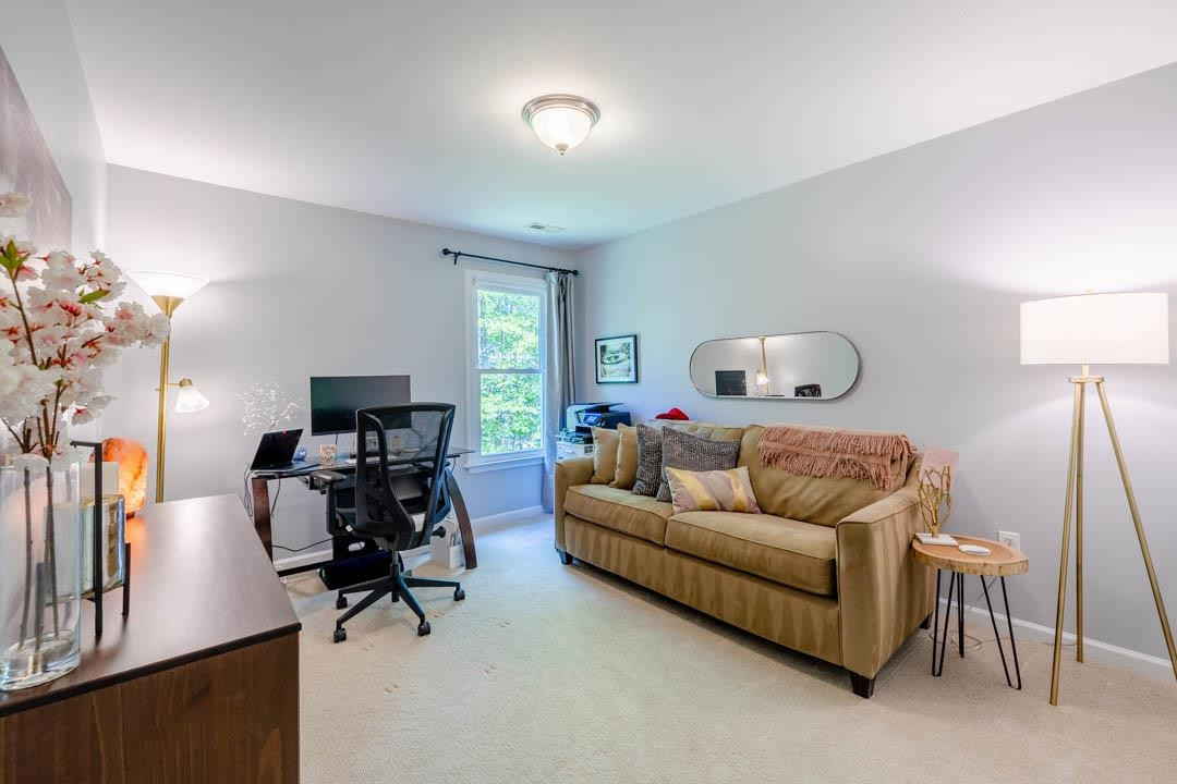 7402 Leapale Lane Durham, NC 27713 - Photo 25 of 41 a living room with furniture and a flat screen tv