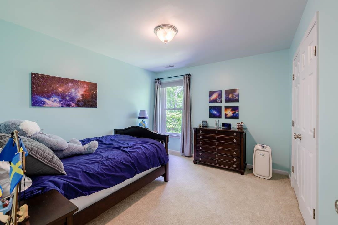 7402 Leapale Lane Durham, NC 27713 - Photo 26 of 41 a spacious bedroom with a bed and a cabinets