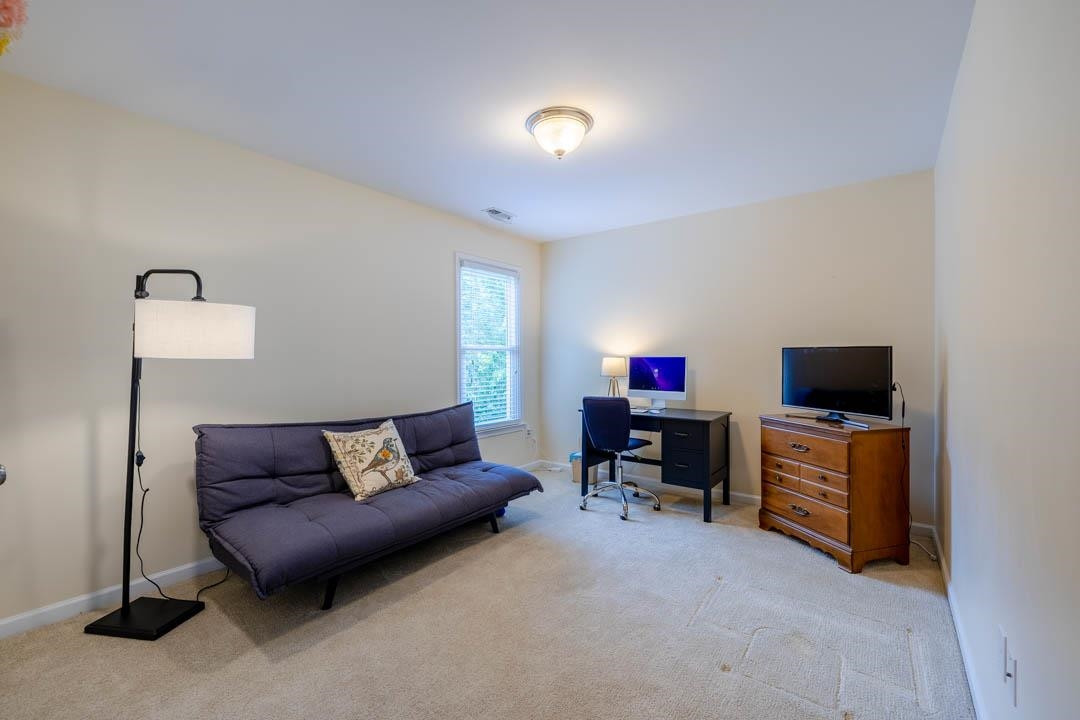 7402 Leapale Lane Durham, NC 27713 - Photo 27 of 41 a living room with furniture and a flat screen tv
