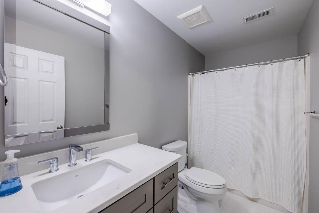 7402 Leapale Lane Durham, NC 27713 - Photo 28 of 41 a bathroom with a sink toilet and a mirror