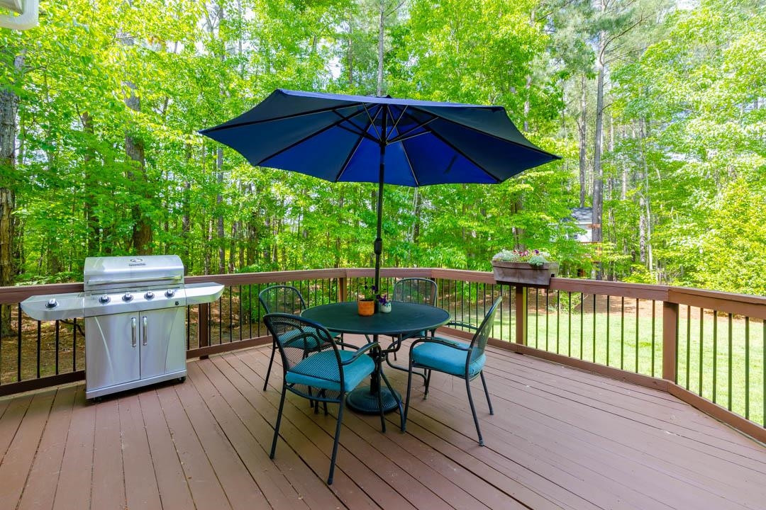7402 Leapale Lane Durham, NC 27713 - Photo 31 of 41 a view of a deck with furniture and barbeque grill with wooden fence