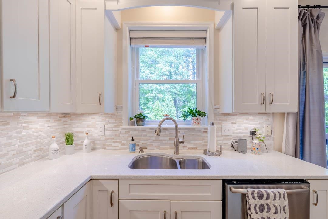 7402 Leapale Lane Durham, NC 27713 - Photo 10 of 41 a kitchen with stainless steel appliances granite countertop white cabinets sink and window