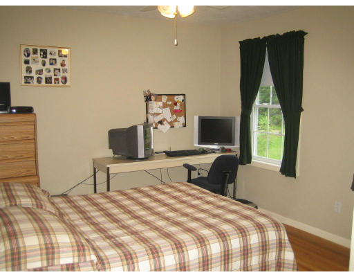 22 A Vinton Road Charlton, MA 01507 - Photo 17 of 24 a bedroom with a bed and a flat tv screen on dresser