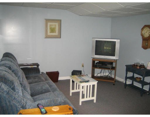 22 A Vinton Road Charlton, MA 01507 - Photo 23 of 24 a living room with furniture a flat screen tv and a fireplace
