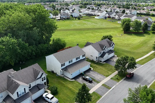 an aerial view of a house with a garden and swimming pool