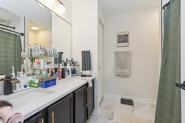 a kitchen with a sink dishwasher and a refrigerator with wooden floor