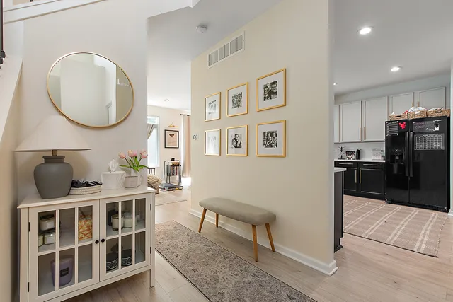a living room with furniture a rug and a large mirror