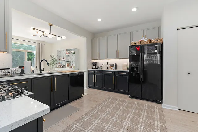 a kitchen with a sink cabinets and stainless steel appliances