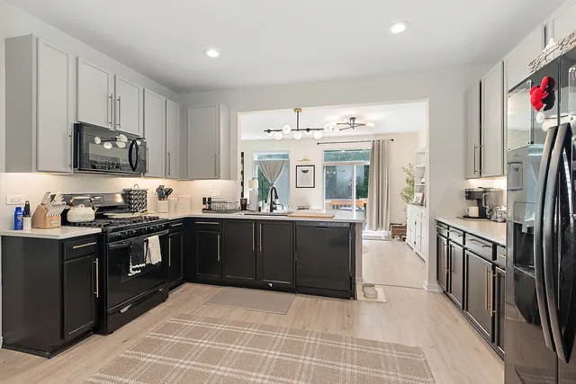 a kitchen with stainless steel appliances granite countertop a refrigerator and a stove top oven