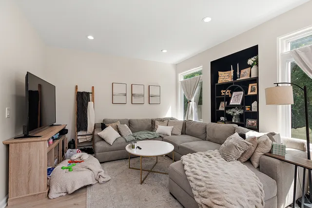 a living room with furniture and a flat screen tv