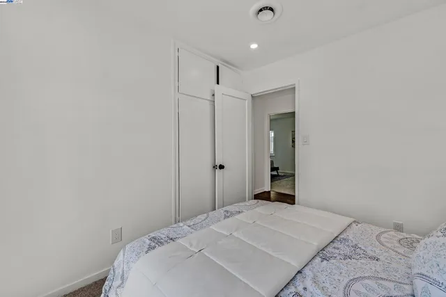 a bedroom with a bed and a mirror