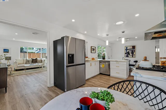 a kitchen with a refrigerator and a counter top space