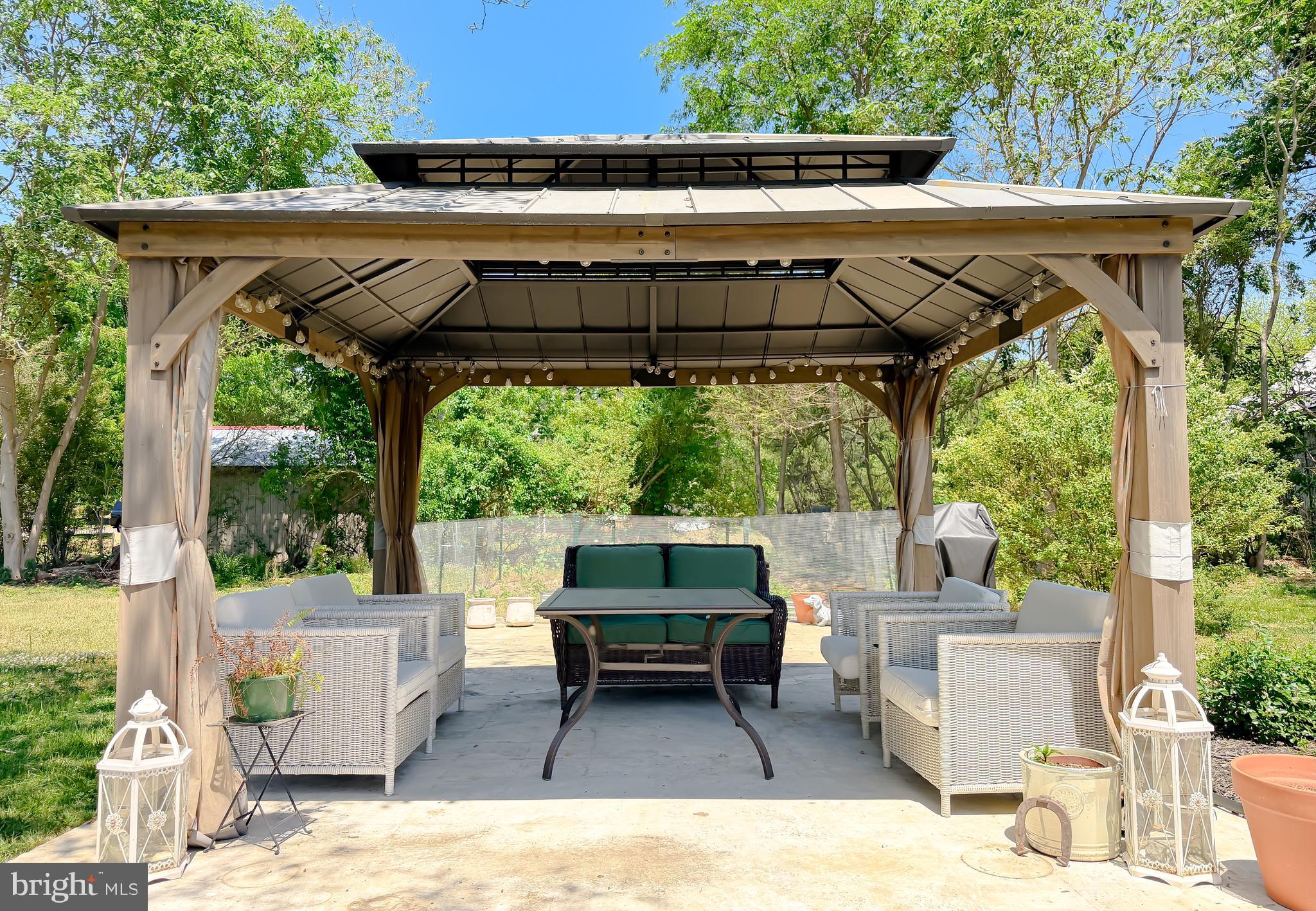 4985 Solomons Island Road Huntingtown, MD 20639 - Photo 39 of 50 a backyard of a house with a table and chairs