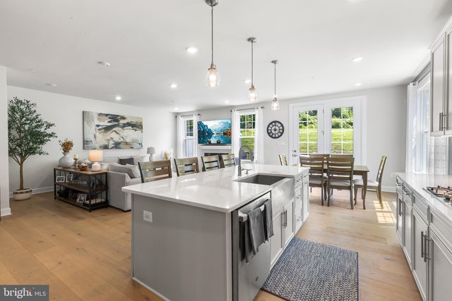 a large white kitchen with a large window