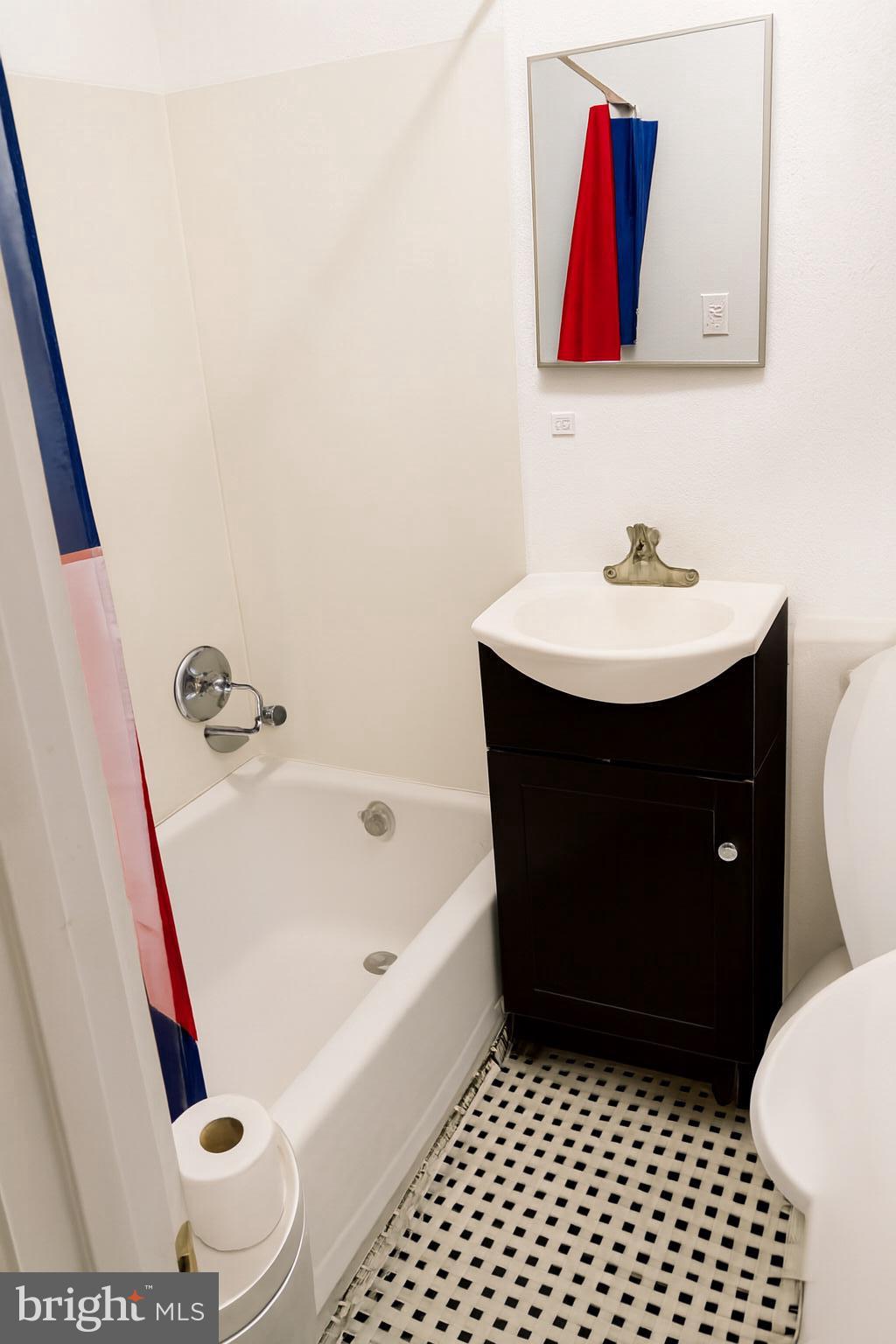 3928 8th Street Baltimore, MD 21225 - Photo 2 of 5 Downstairs unit full bathroom. Photos enhanced.