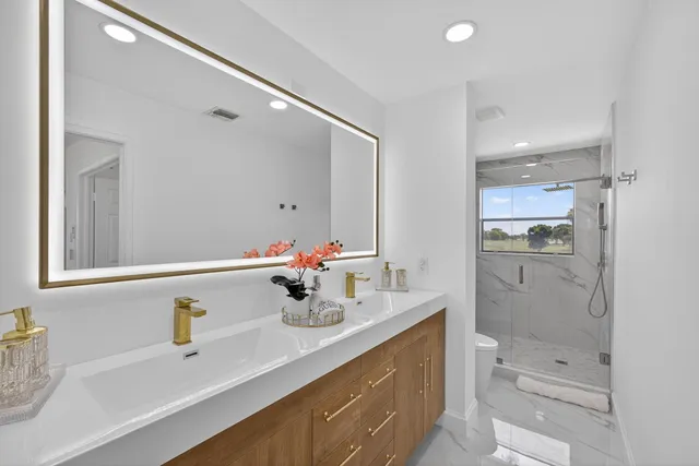 an aerial view of residential houses with outdoor space and trees