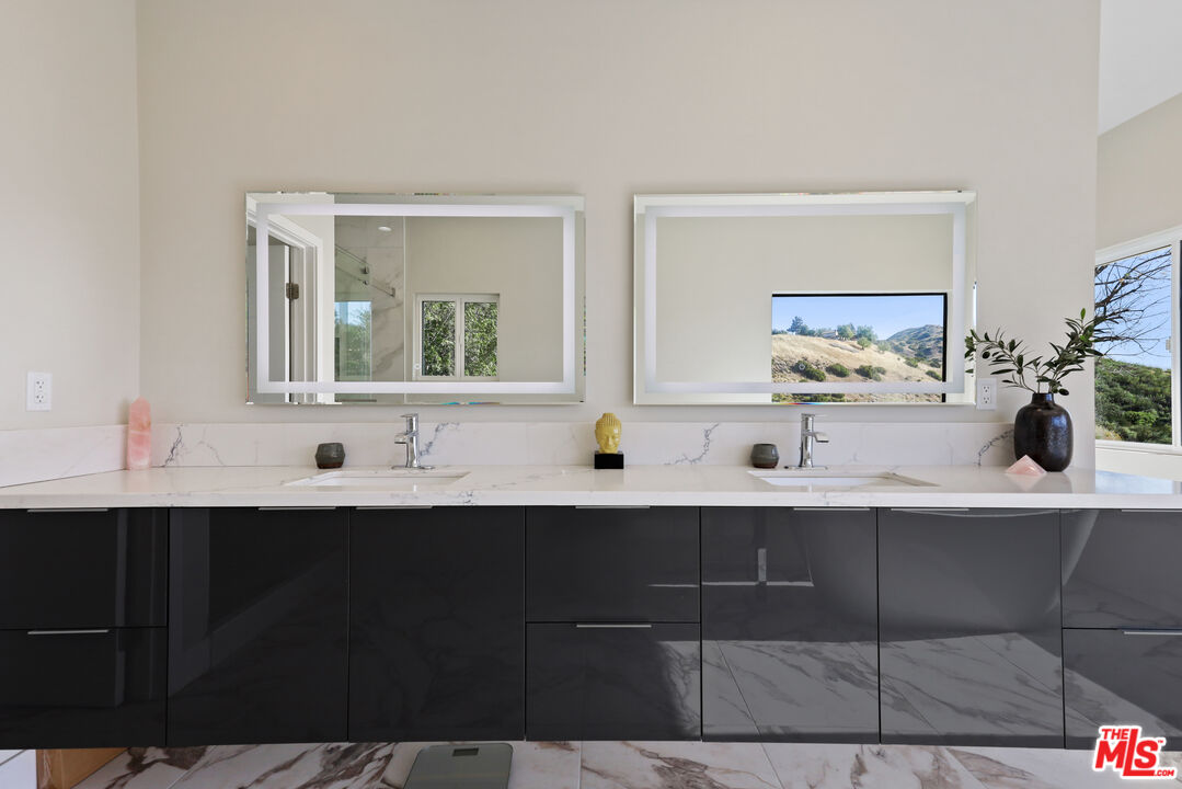 53 Saddlebow Road Bell Canyon, CA 91307 - Photo 40 of 66 a bathroom with a sink and a mirror