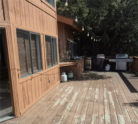 a view of a patio with a table and chairs and wooden floor