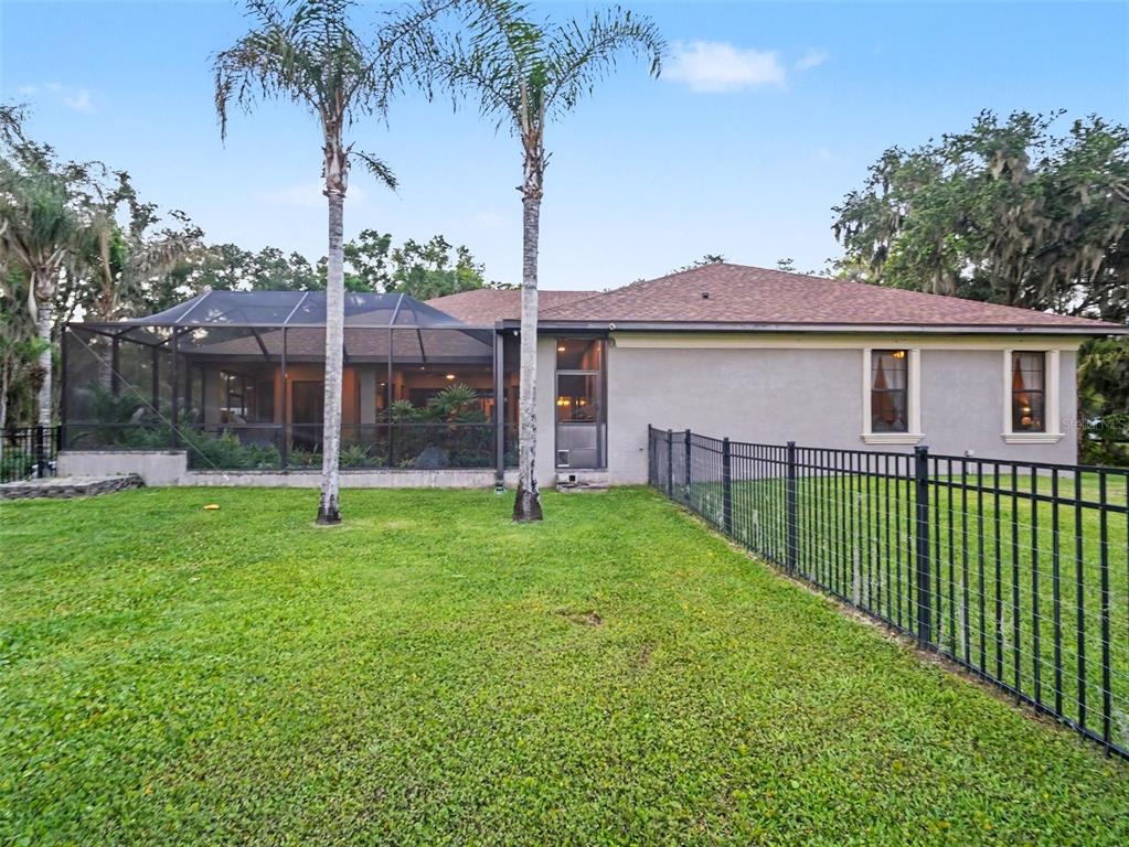 339 Corbett Road Lithia, FL 33547 - Photo 34 of 38 a view of a house with a backyard and a garden