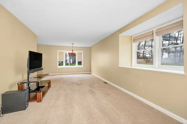 a living room with projector and a flat screen tv