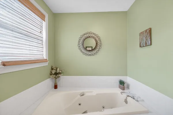 a white toilet sitting next to a bath tub