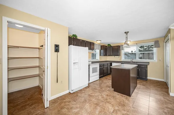 a kitchen with refrigerator and cabinets