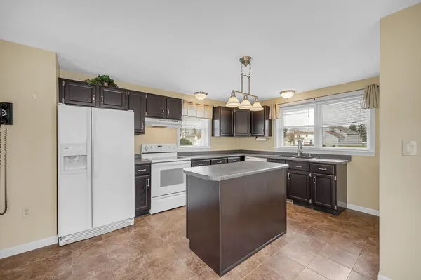 a kitchen with a sink stainless steel appliances and cabinets