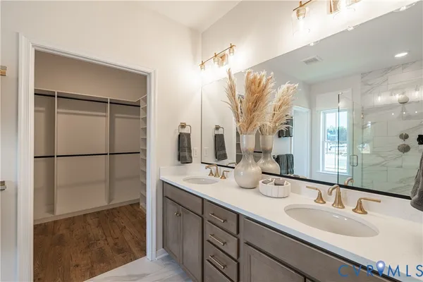 a bathroom with a double vanity sink and mirror