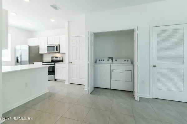 a kitchen with a sink a stove and cabinets
