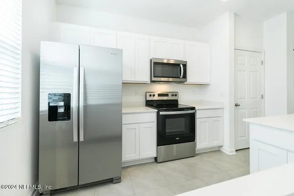 a kitchen with a refrigerator stove and microwave